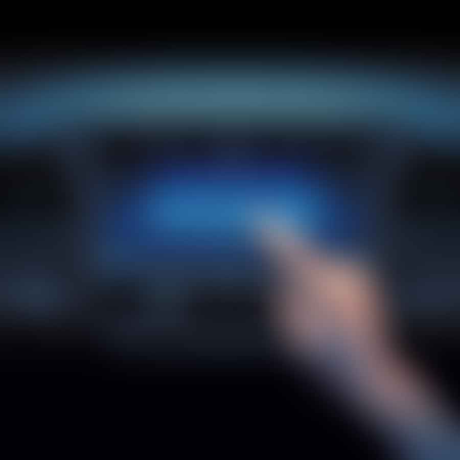 A hand pressing the reset button on a Subaru's dashboard screen